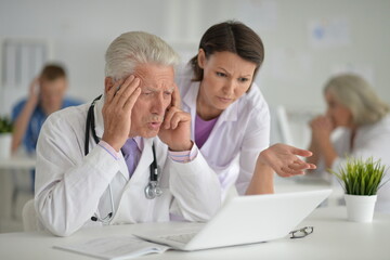 Fototapeta premium Male doctor sitting at table in clinic