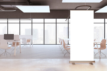 Clean coworking office interior with empty white roll-up banner, panoramic window and city view, equipment and furniture. Mock up, 3D Rendering.