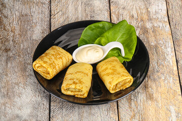 Stuffed pancakes with cream sauce