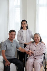 Obraz premium Portrait of smiling senior parents and adult daughter at home
