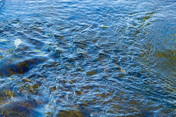 flow of water and spray from a stone