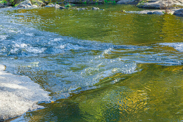 flow of water and spray from a stone