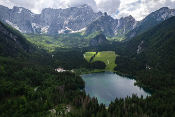 Fusine Lake in Italy with Alps mountains in background , Europe. Aerial drone view.