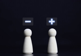 Wooden blocks showing plus and minus signs. The concept of antithesis. Decision making. Positive or...