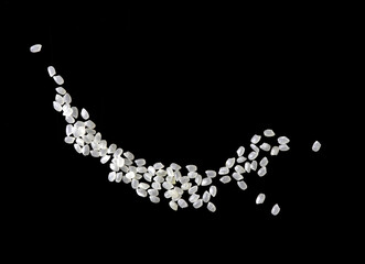 Heaps of uncooked Japanese short grain rice piled together isolated on black background.	
