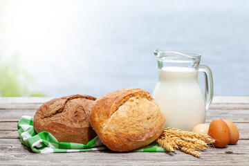 Homemade bread and milk on wooden table