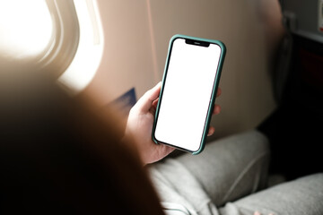 Touching and slide mobile phone screen on airplane or aircraft,blank mobile phone screen mock up,selective focus © Thaspol