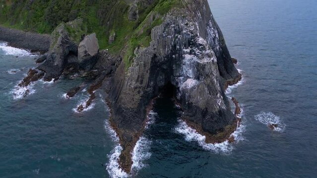 Itoshima, Japan: Aerial drone footage of the dramatic Keya no Ohto cliff and coastline in the Kyushu island near Fukuoka in Japan at dusk. Shot with a tilt up motion