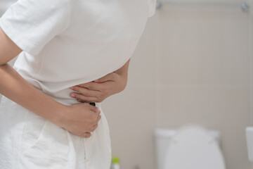 Constipation and diarrhea in bathroom. Hurt woman touch belly  stomach ache painful. colon inflammation problem, toxic food, abdominal pain, abdomen, constipated in toilet, stomachache, Hygiene - obrazy, fototapety, plakaty