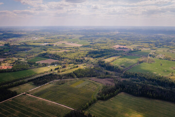 aerial view over the green fields of early summer and the double carriageway from the air.