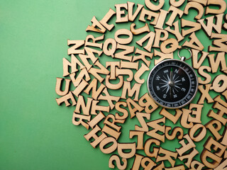 Top view wooden letter and compass