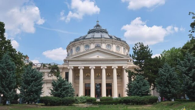 Romanian Athenaeum (Ateneul Roman), a landmark in Bucharest, Romania. Timelapse of white Summer clouds above this domed, circular concert hall building, opened in 1888.