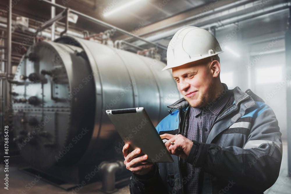 Poster portrait of the engineer checking the reliability and serviceability of the boiler system