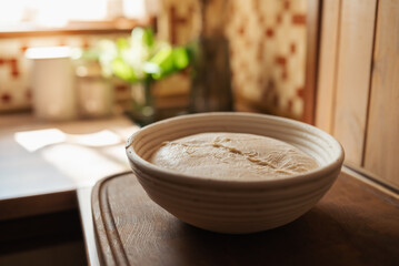 Dough for bread in wooden plate before baking it. Baking bread following all the rules to make it tasty and airy