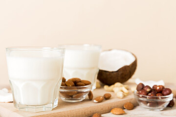 Set or collection of various vegan milk almond, coconut, cashew, on table background. Vegan plant based milk and ingredients, top view