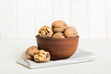 Fresh healthy walnuts in bowl on colored table background. Top view Healthy eating bertholletia concept. Super foods