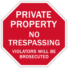 Stop no trespassing warning sign and labels violators will be prosecuted