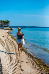 jeune femme marchant le long de la plage