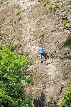 A climber at via ferrata at the beautiful Talbach waterfall in Tyrol - Austria