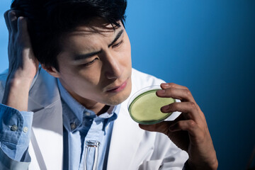 A male scientist conducting research with a petri dish