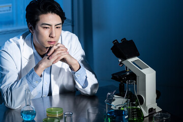 A male scientist conducting research with serious look
