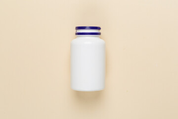 Plastic bottle with vitamins on color background, top view