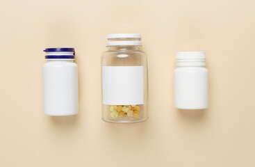 Plastic bottles with vitamins on color background, top view