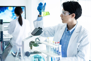 A male scientist conducting research with a flask