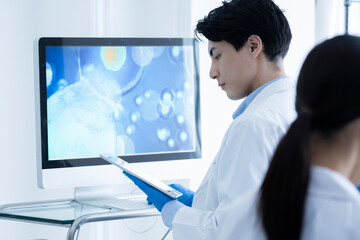 A male scientist conducting research with digital tablet