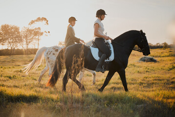 Horse riding, countryside and hobby with friends in nature on horseback through a field during a...