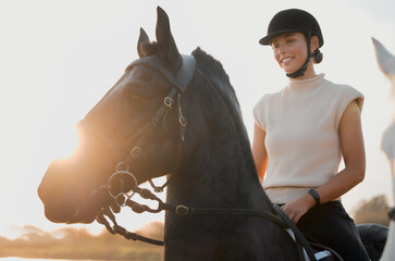Horse riding, smile and woman in countryside at sunset outdoor for freedom. Equestrian, girl and...