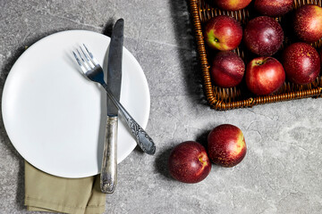 Fresh sweet ripe peaches in basket on gray grunge background