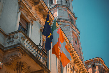 Flags and Architecture: A captivating image showcases the vibrant flags of European Union and a...