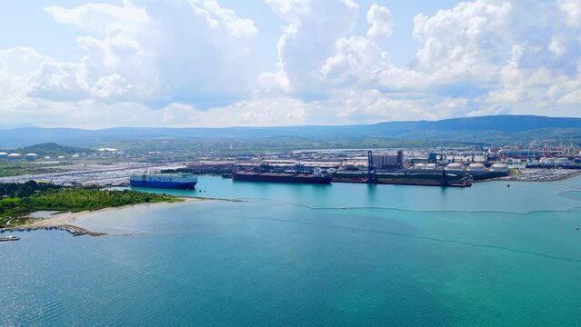 Stunning aerial 4K drone footage of Luka Koper, Slovenia. Explore the vibrant maritime hub, busy port operations, and scenic coastal beauty. Perfect for showcasing commercial and coastal themes.