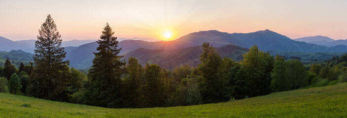Panorama of mountain ridges at sunset in the Carpathian Mountains