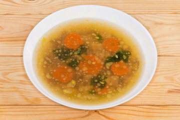 Chicken jelly in the white bowl on the rustic table