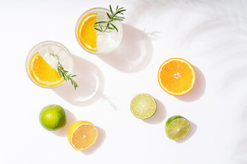 Summer cocktails with citrus fruits orange lemon lime mint and rosemary on a white background....