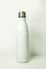 White metal water bottle on white background with copy space for text.