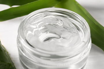 Jar of natural aloe gel on table, closeup