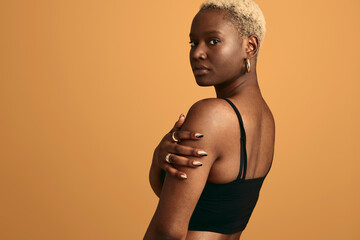 Black woman touching shoulder in studio