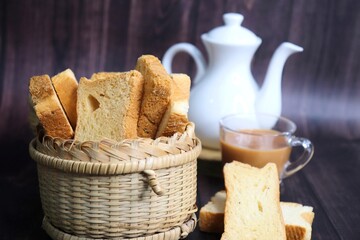 Tea Time Snack. Healthy Wheat rusk served with Indian hot masala tea and milk jug over black...