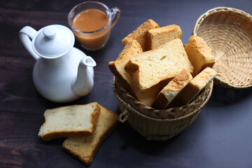 Tea Time Snack. Healthy Wheat rusk served with Indian hot masala tea and milk jug over black...