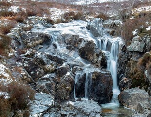 Breathtaking landscape featuring a small, cascading waterfall flowing