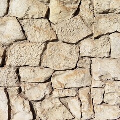 Closeup of an old wall with different shapes of stones.