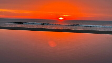 Stunning view of a bright vibrant sunset sky over a sea