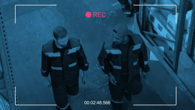 High angle security camera shot of multi-ethnic people working together in stockroom with construction materials on shelves