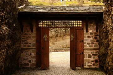 Fototapeta na wymiar Metal door placed in a stone archway
