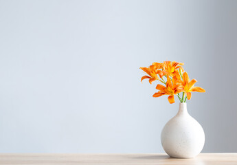 summer flowers in white modern vase on wooden shelf © Maya Kruchancova