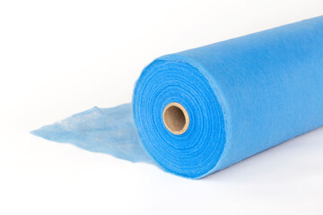 A roll of blue fabric, a sheet for massage, on a white background.