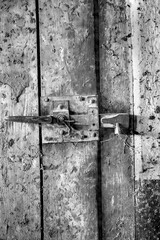 Old rustic door close up.Vertical view. Black and white